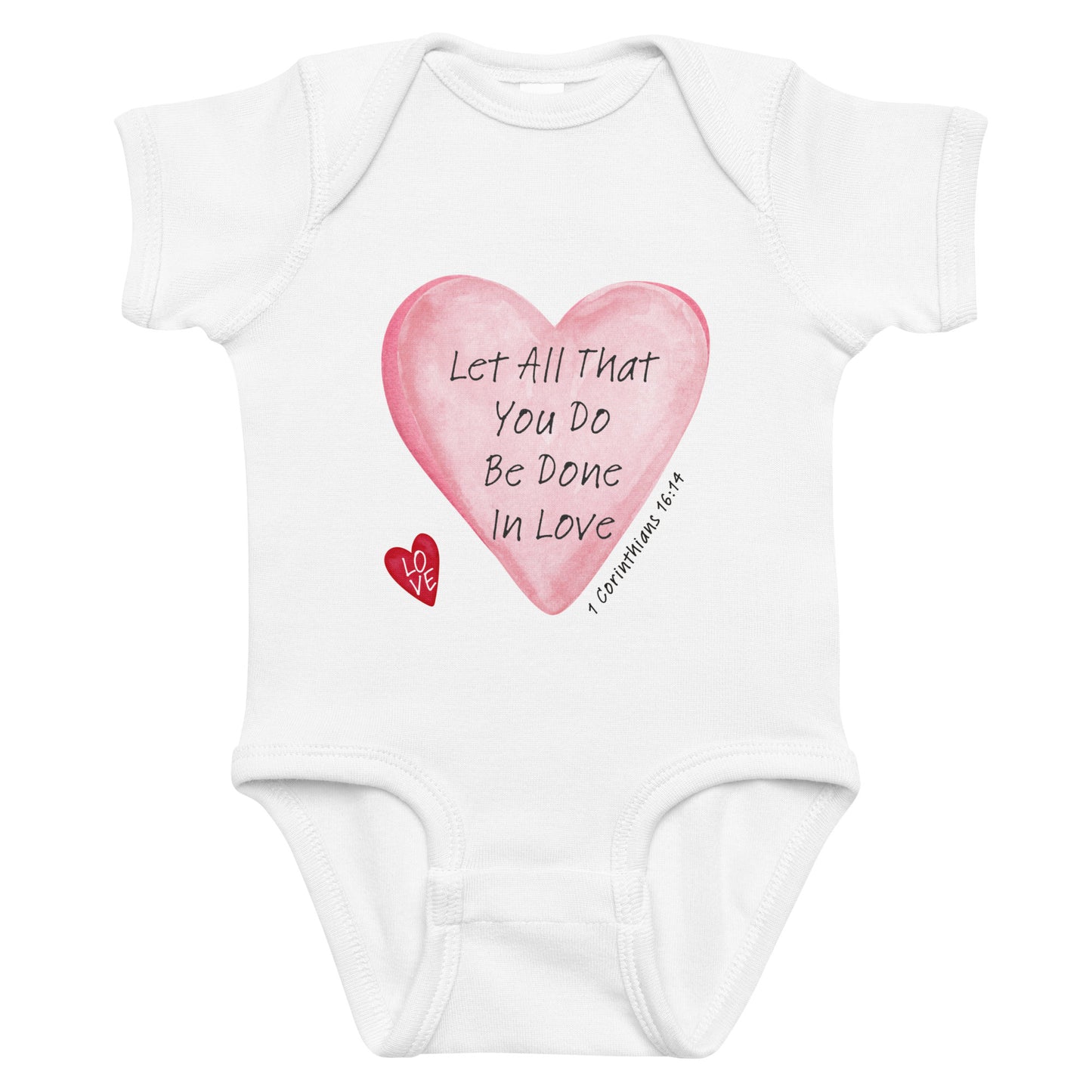 White baby onesie with pink heart design and text on a white background
